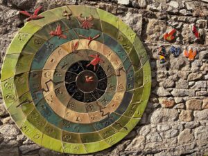 Ceramic mural at St. Declan’s School, with colourful circular tiles and birds on a stone wall